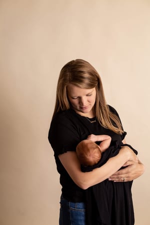 young mom holds new baby girl
