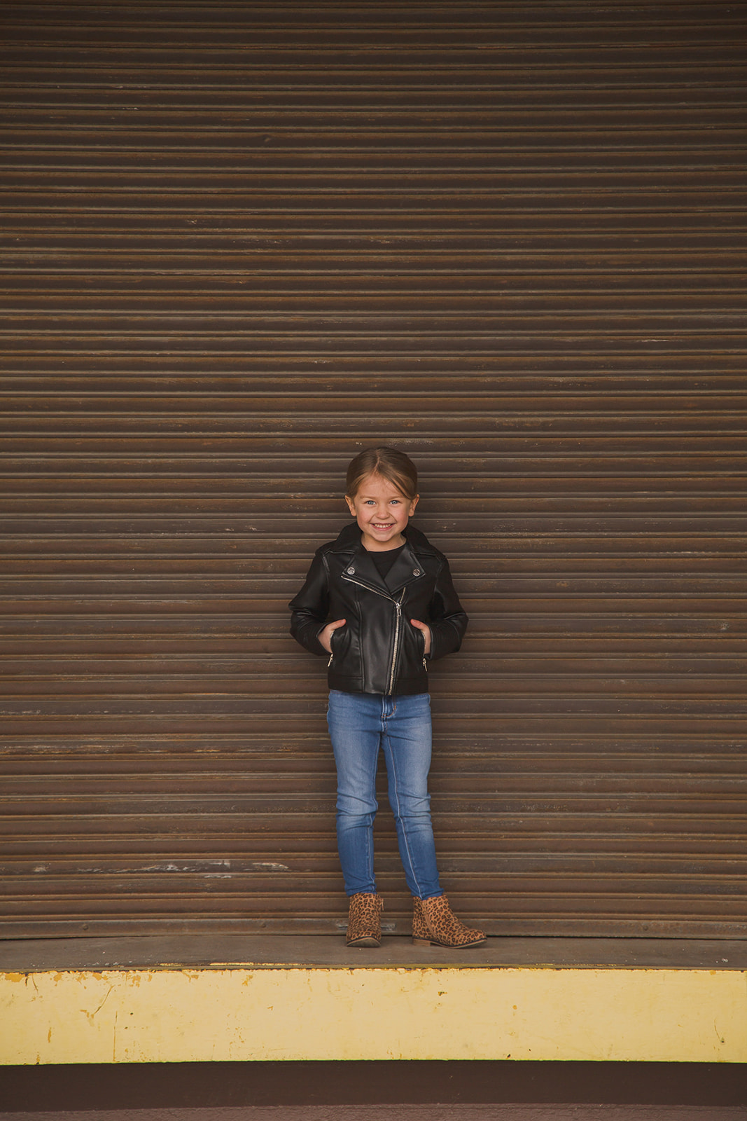 young smiling girl in cool jacket